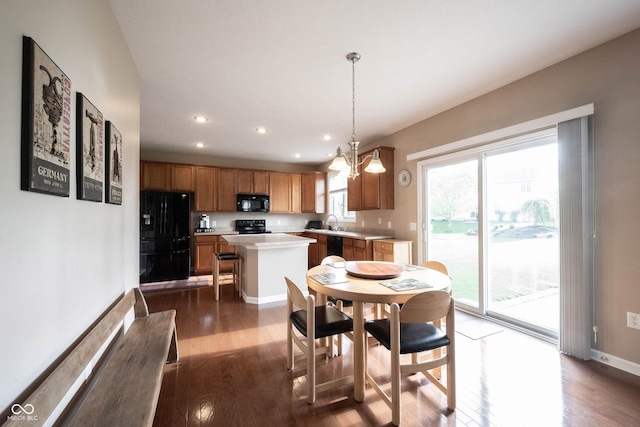 dining space with recessed lighting, baseboards, dark wood-style floors, and an inviting chandelier