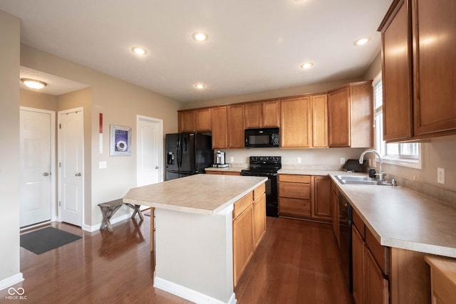 kitchen with a sink, light countertops, a center island, dark wood-style floors, and black appliances