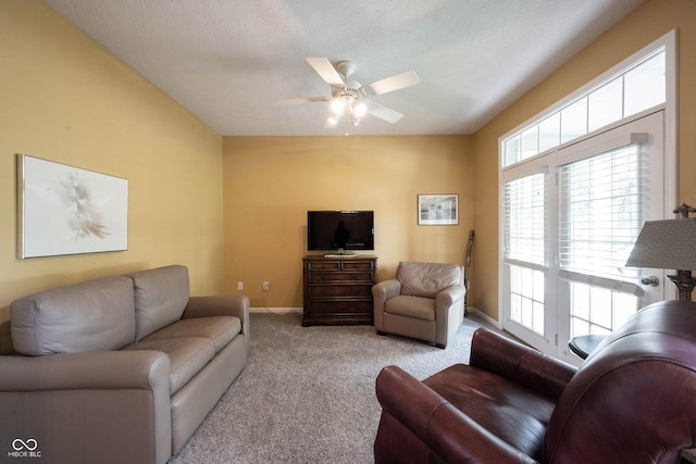 living area with carpet flooring, ceiling fan, and baseboards