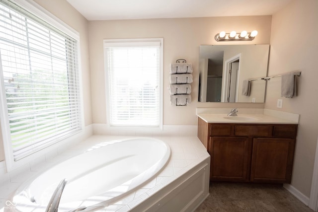 bathroom featuring a garden tub and vanity