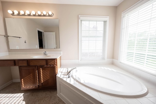 full bath featuring tile patterned floors, a bath, and vanity