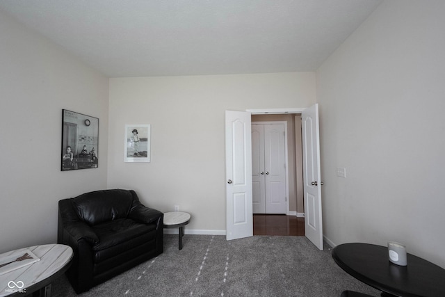 sitting room featuring carpet floors and baseboards