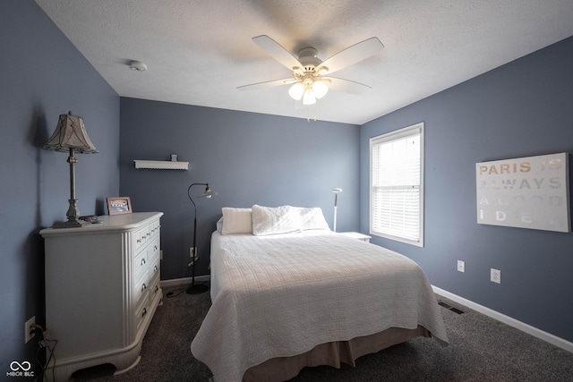 bedroom with baseboards, a ceiling fan, dark carpet, and visible vents