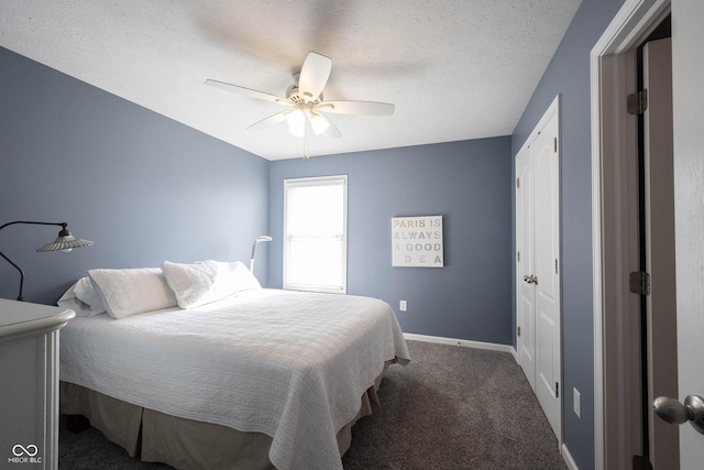 bedroom with carpet floors, a ceiling fan, baseboards, and a textured ceiling