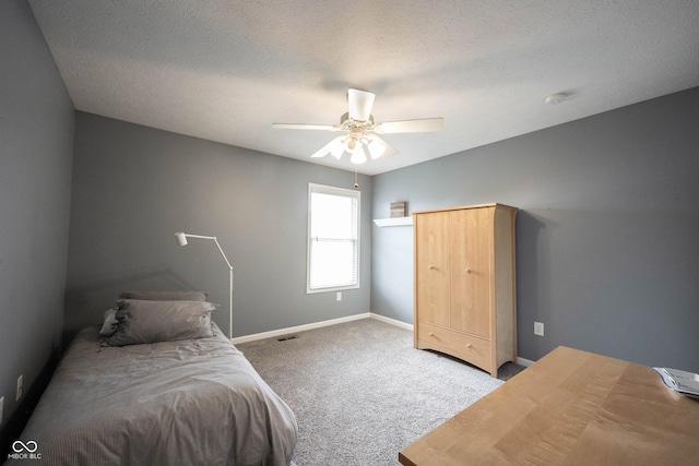 bedroom with visible vents, baseboards, ceiling fan, a textured ceiling, and carpet flooring