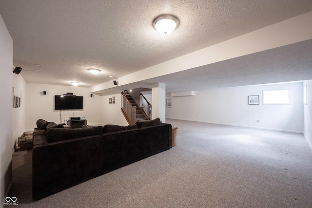 carpeted living area with a textured ceiling and stairs