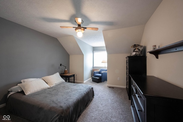 carpeted bedroom with a ceiling fan, baseboards, vaulted ceiling, and a textured ceiling