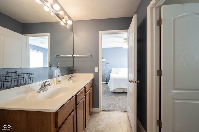 full bathroom with double vanity, a sink, connected bathroom, and tile patterned floors