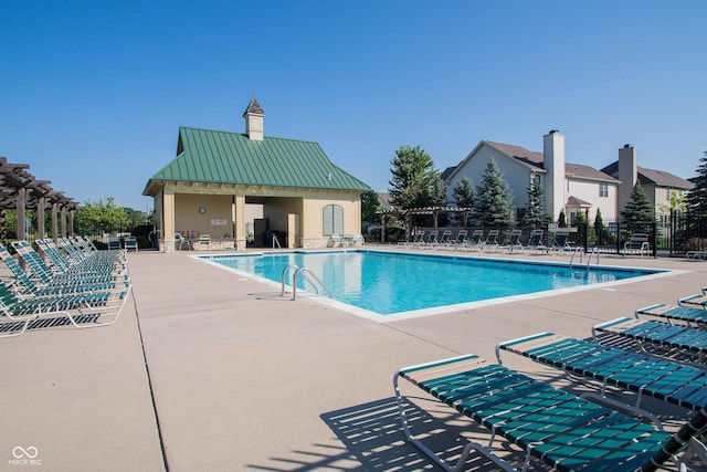 pool with fence and a patio area