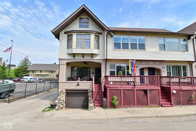 114 E 27th St, Indianapolis, IN 46205 - view of property with stairway, driveway, a porch, fence, and an attached garage