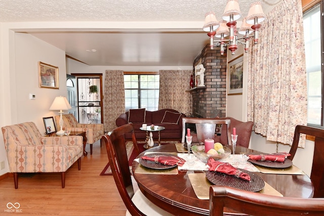 114 E 27th St, Indianapolis, IN 46205 - dining area featuring wood finished floors, a chandelier, and a textured ceiling