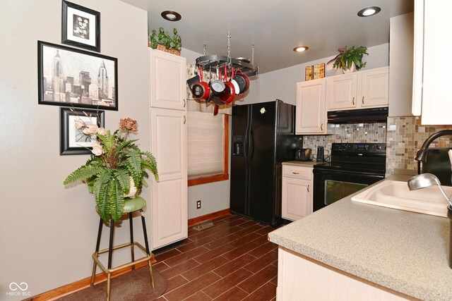 114 E 27th St, Indianapolis, IN 46205 - kitchen featuring black appliances, under cabinet range hood, decorative backsplash, white cabinetry, and recessed lighting