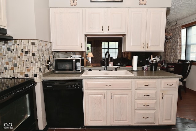 114 E 27th St, Indianapolis, IN 46205 - kitchen with black appliances, a sink, white cabinetry, and decorative backsplash