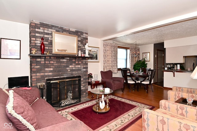 114 E 27th St, Indianapolis, IN 46205 - living room featuring wood finished floors and a brick fireplace