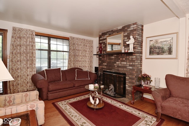 114 E 27th St, Indianapolis, IN 46205 - living room featuring wood finished floors, plenty of natural light, and a brick fireplace