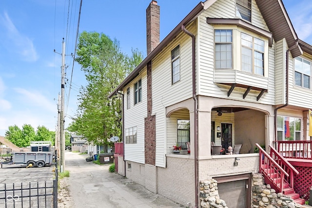 114 E 27th St, Indianapolis, IN 46205 - view of side of home featuring a chimney and an attached garage