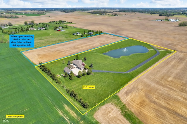 birds eye view of property with a water view and a rural view