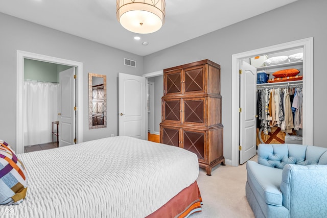 bedroom featuring visible vents, a closet, a walk in closet, recessed lighting, and light colored carpet