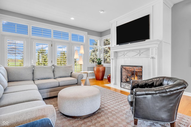 living room featuring recessed lighting, wood finished floors, and a wealth of natural light