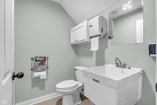 half bath featuring visible vents, lofted ceiling, toilet, baseboards, and a sink