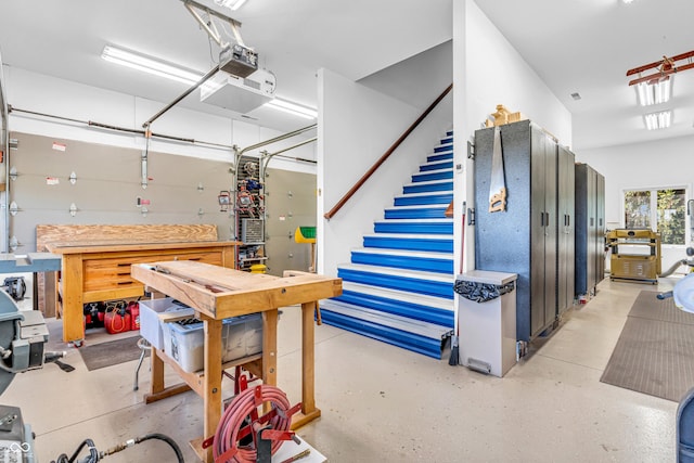 garage featuring a garage door opener and a workshop area