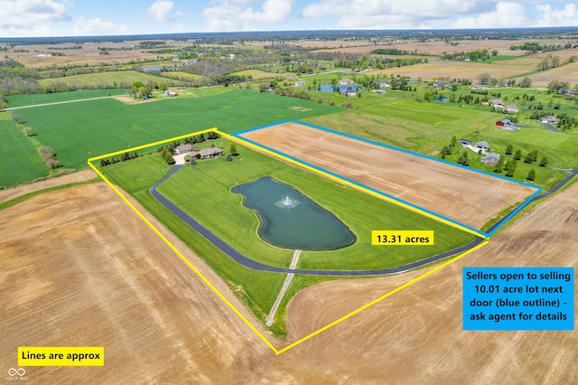 drone / aerial view featuring a water view and a rural view