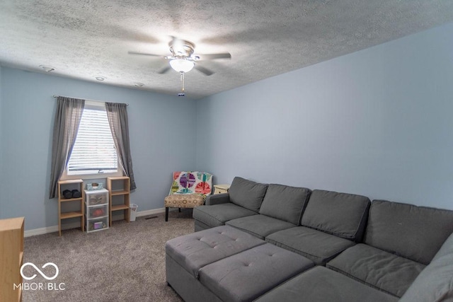carpeted living area featuring baseboards, a ceiling fan, and a textured ceiling