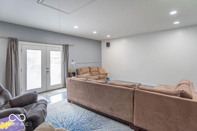 living area with french doors, attic access, and recessed lighting
