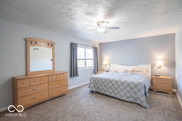 carpeted bedroom featuring baseboards, a textured ceiling, and ceiling fan