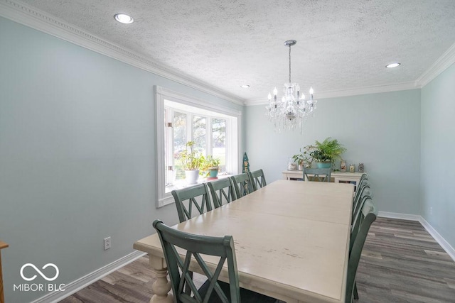 dining area featuring ornamental molding, baseboards, dark wood-style floors, a textured ceiling, and a notable chandelier