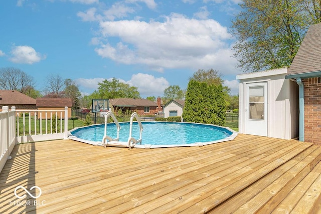 pool with fence and a deck