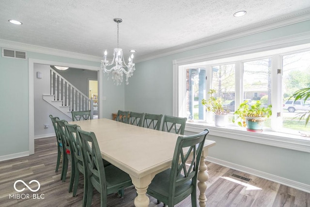 dining room with visible vents, stairs, a textured ceiling, and baseboards