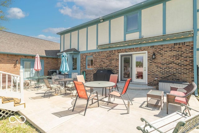view of patio with outdoor dining area and central air condition unit