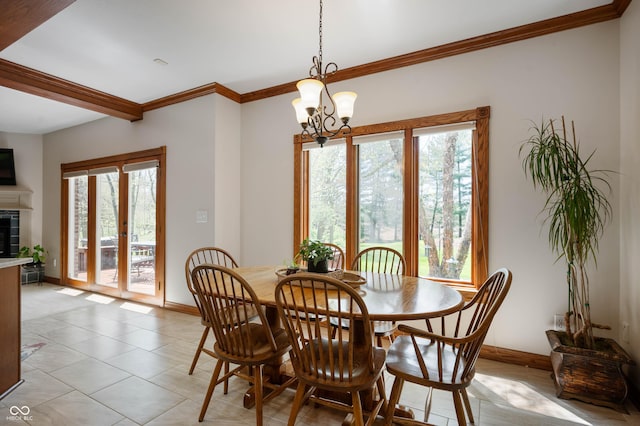 dining space with ornamental molding, a fireplace, baseboards, french doors, and a notable chandelier