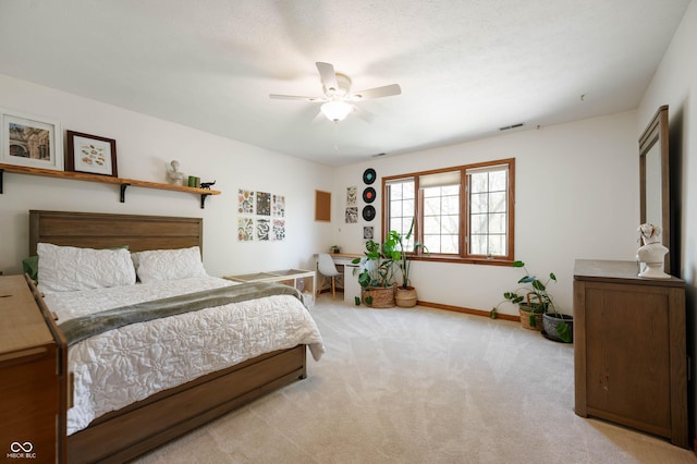 bedroom with light colored carpet, a ceiling fan, baseboards, and visible vents