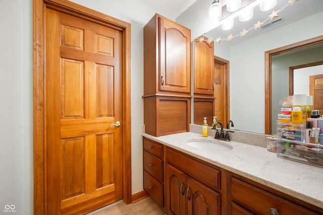 bathroom featuring vanity, wood finished floors, and visible vents