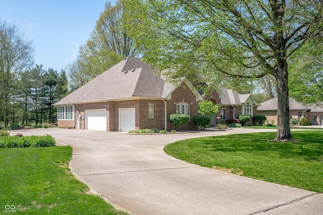 ranch-style home with a shingled roof, an attached garage, a front lawn, brick siding, and driveway