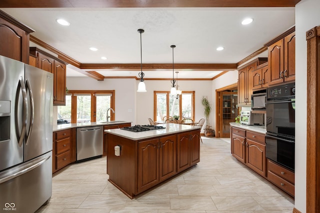 kitchen featuring a sink, a kitchen island, black appliances, and a healthy amount of sunlight