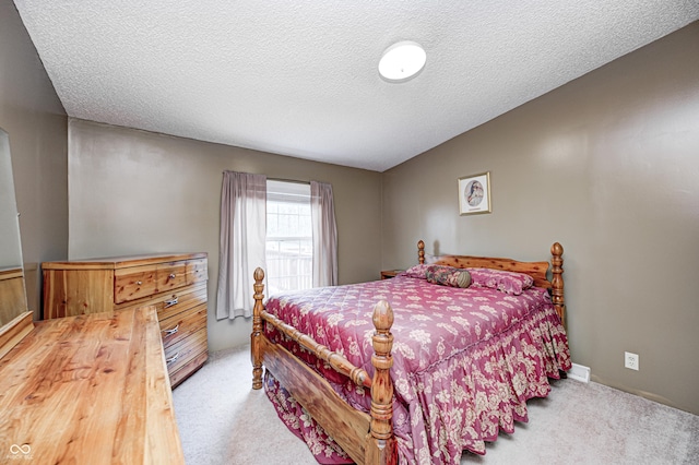 bedroom featuring carpet flooring and a textured ceiling