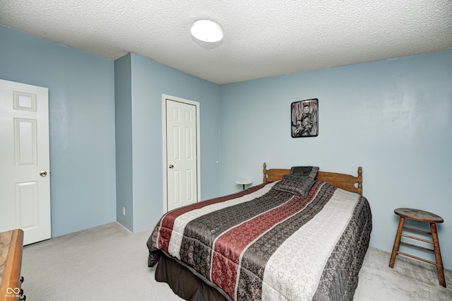 carpeted bedroom featuring a textured ceiling