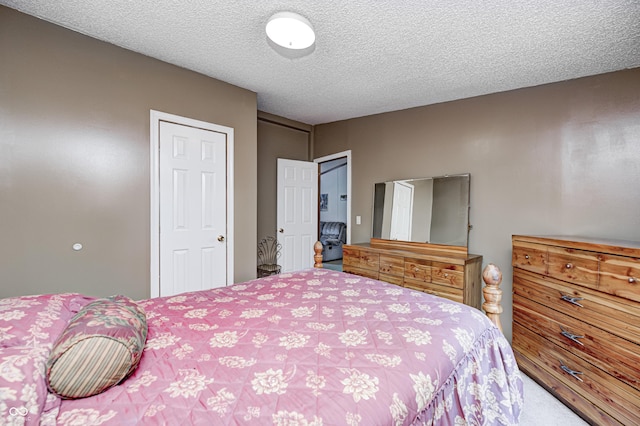 carpeted bedroom featuring a textured ceiling