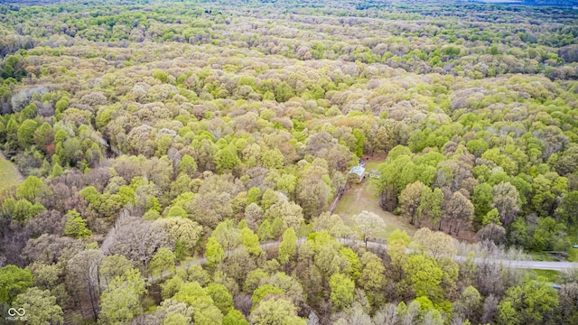 bird's eye view with a wooded view
