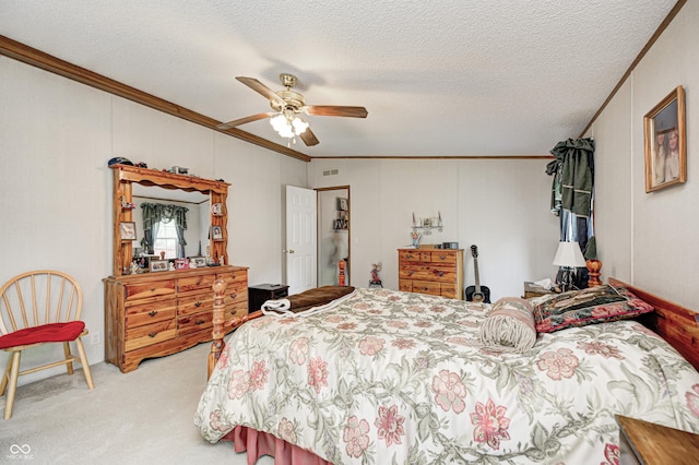 bedroom featuring carpet flooring, a textured ceiling, ornamental molding, and ceiling fan
