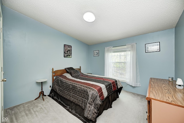 bedroom featuring carpet floors and a textured ceiling