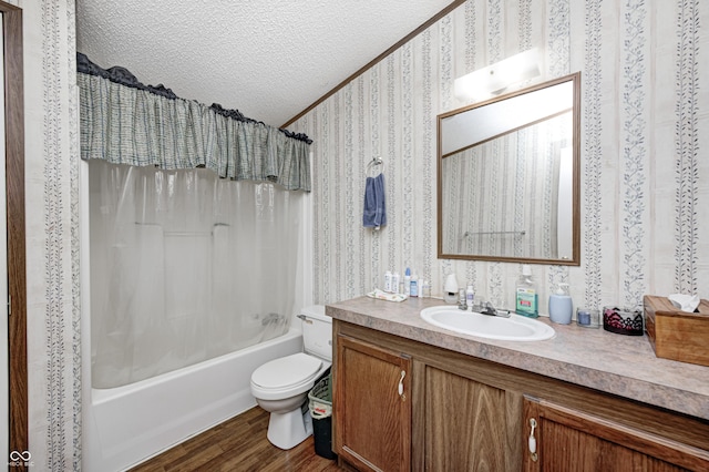 full bath featuring vanity, wood finished floors, wallpapered walls, a textured ceiling, and shower / bath combo