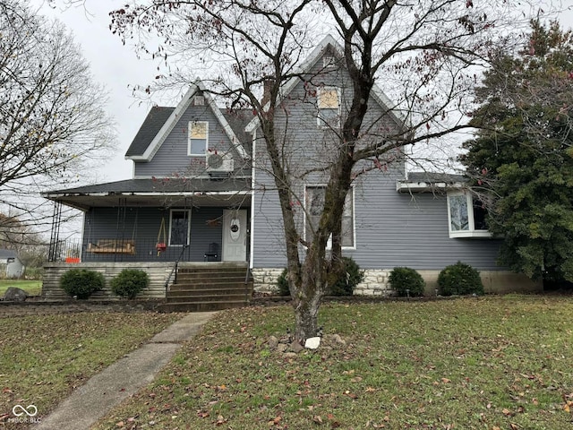 view of front of home with a porch and a front yard