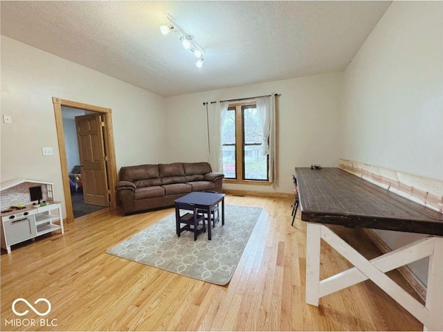 living room featuring a textured ceiling and wood finished floors