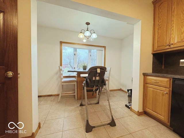 dining area featuring baseboards, light tile patterned flooring, and a notable chandelier