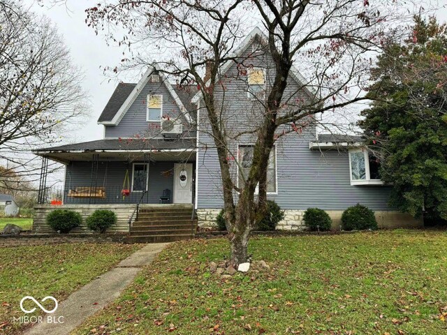 view of front of home featuring a porch and a front yard