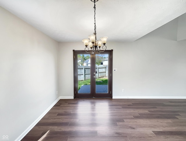 6628 Dunsdin Dr, Plainfield, IN 46168 - unfurnished dining area featuring french doors, dark wood-style flooring, baseboards, and a notable chandelier